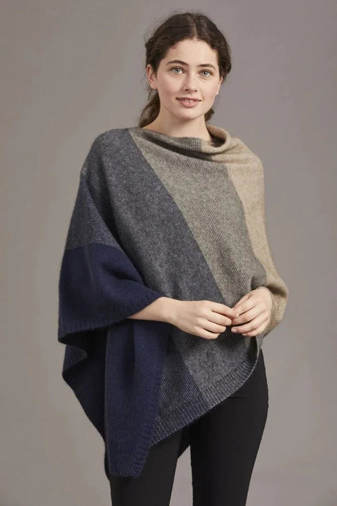 Possum and Merino

5010 Ombre Poncho - Our signature Ombre Poncho is available in five beautiful colour combinations. The incredible drape and classic style of this poncho will make it your go-to piece whenever there is a chill in the air.

Ombre Colour Pattern front and back
Mid-weight Warmth
35% Possum Fur, 55% Merino Wool, 10% Pure Mulberry Silk
New Zealand Designed and Manufactured

Natural and Sustainable
One Size Fits Most
Approximate size: Width 78 cm Length 66 cm.
