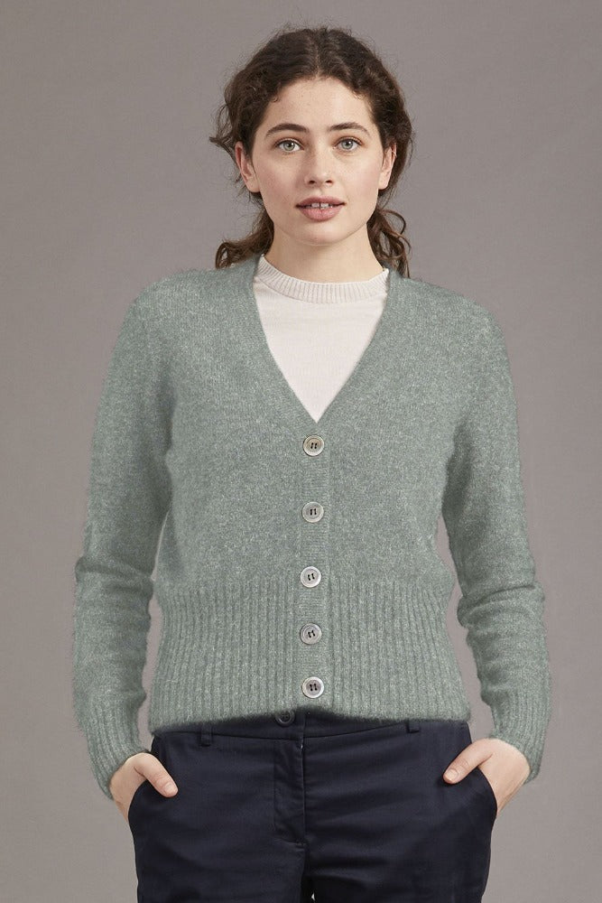 Possum and Merino  5034 Rib Cardi is knitted using our carefully sourced Natural Fibre blend of Possum Fur, Merino Wool and Mulberry Silk and finished with feature Shell Buttons, our Possum Merino Rib Cardi is a gorgeous take on a classic cardigan.  Rib detailing on the sleeve and hem partnered with a Deep V Neckline help to create a timeless, tailored look.