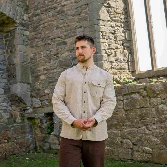 Celtic collarless dress shirt for men in beige, styled outdoors with long sleeves and heritage-inspired tailoring