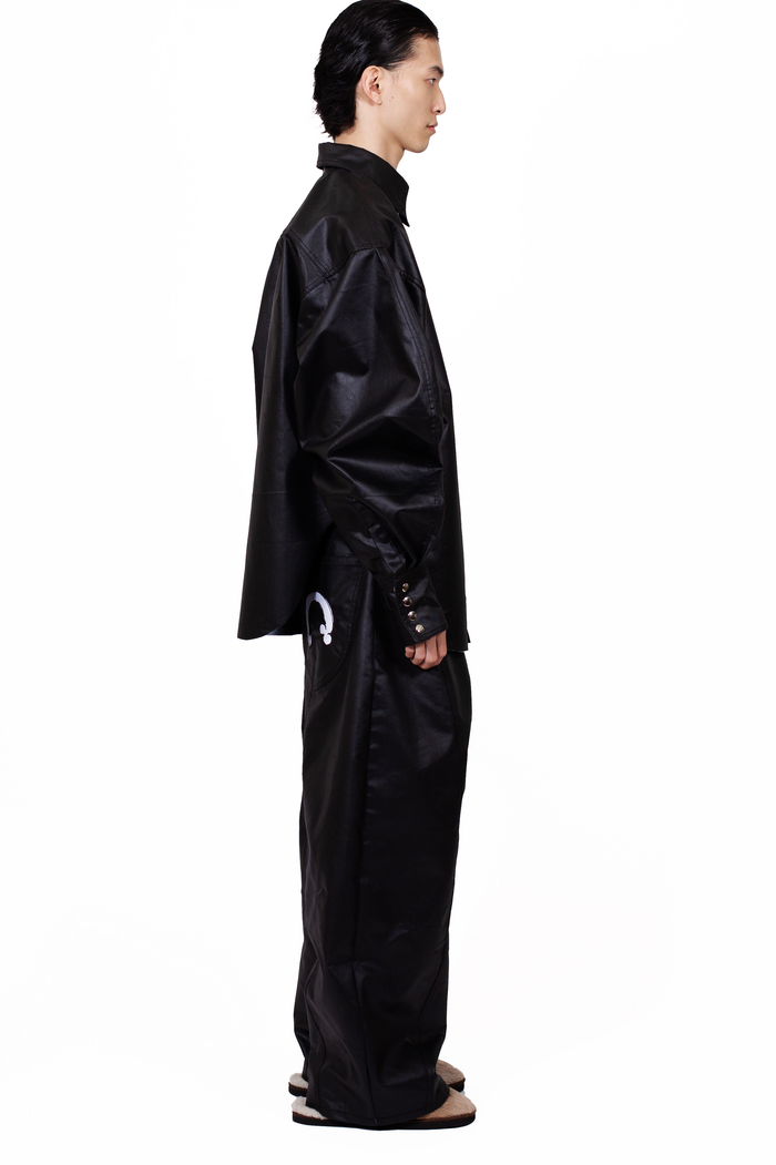 MANCANDY Coated Biker Baggy Jeans in black coated denim featuring articulated panel construction, knee pocket detail and embroidered back pockets.