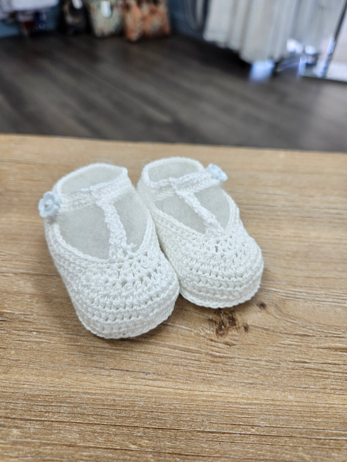Crochet baby bootie with flower button.