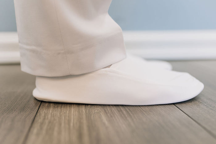 Plain white soft slippers for men.