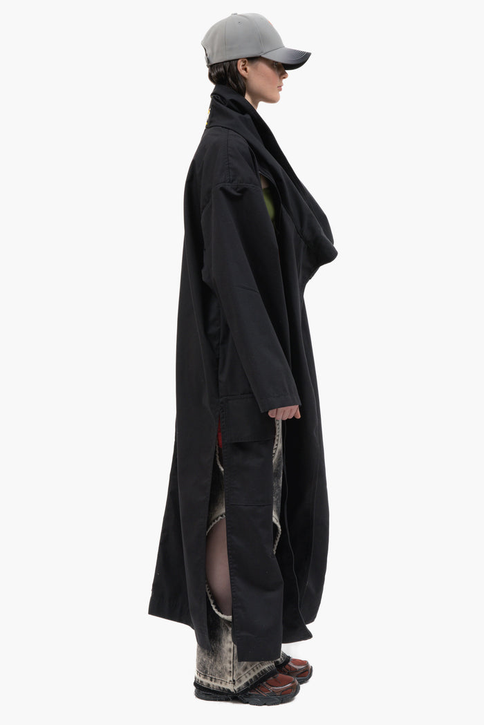 MANCANDY Nomad Trench in black cotton twill featuring a convertible scarf collar, oversized silhouette and multiple styling options.