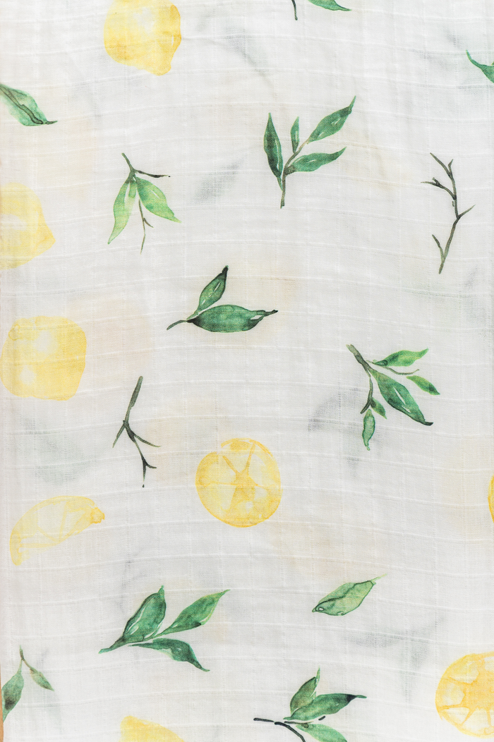 Lightweight organic cotton swaddle in soft yellow tones